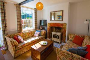 a living room with a couch and a fireplace at Flint Cottage - 2 Bedrooms - Rye Town Centre in Rye