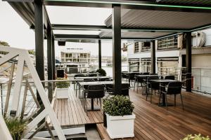 a balcony with tables and chairs on a building at Vogue Boat Apartments in Budapest