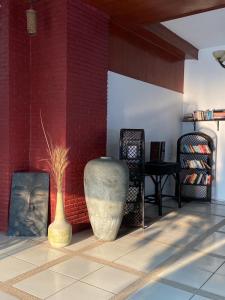two vases sitting on a floor next to a brick wall at Chaweng Residence in Chaweng