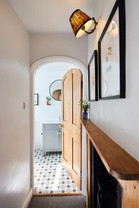 a hallway with a door and a tile floor at Cottage on The Croft in Hungerford