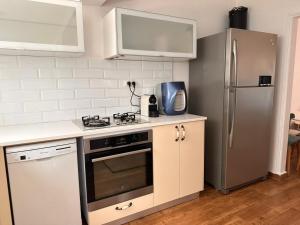 a kitchen with a stove and a refrigerator at בית בקיבוץ in HaGoshrim