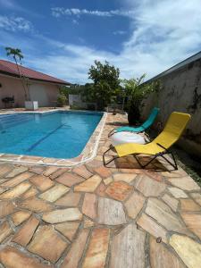 a patio with two chairs and a swimming pool at Kasentof in Cayenne