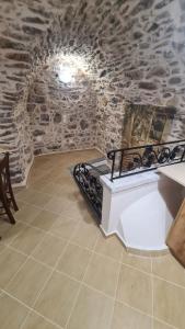 a room with a staircase in a stone wall at Olympus in Olýmpoi