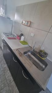 a kitchen with a sink and a stove at Casa de 3 ambientes in Río Grande