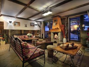 a living room with a couch and a fireplace at Apartment on the slopes in the big ski area Grandes Rousses in Oz