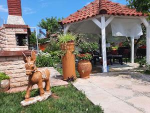 a statue of a kangaroo in front of a patio at Casa Olena in Nea Potidaea