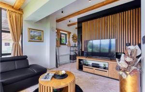 a living room with a couch and a television at Lovely Home In Donja Stubica With Outdoor Swimming Pool in Donja Stubica