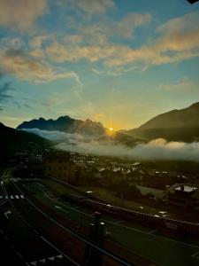 a view of a city with the sun rising above the clouds at C’era una volta un Re… in Calalzo