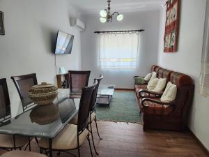 a living room with a table and a couch at Casa da Avó Aninhas in Freixo de Espada à Cinta