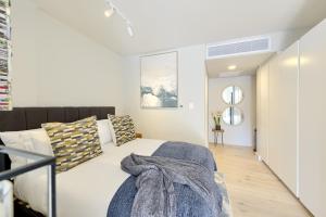 a bedroom with a bed and a mirror at Tokyo Studio with Balcony - Book 4 & Get 5th Night FREE in Cape Town +29 photos