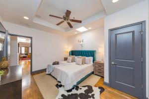 a bedroom with a bed and a ceiling fan at Spacious Penthouse ON the Broadway Strip in Nashville