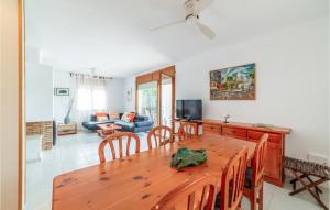 a dining room and living room with a wooden table at Gorgeous Home In Roda De Bara With Kitchen in Roda de Bará