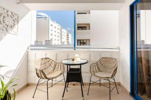 a small table and two chairs on a balcony at Anna's Apartment Praia da Rocha in Portimão