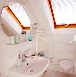 a bathroom with a sink and a mirror at Apartmenthaus Oberndorf 