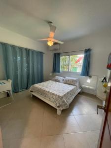 a bedroom with a bed and a ceiling fan at JARDIN SECRET B1 in Las Terrenas