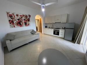 a living room with a couch and a kitchen at JARDIN SECRET B1 in Las Terrenas