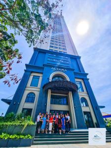 a group of people standing in front of a building at Bluewaves Apartment Quy Nhon in Quy Nhon