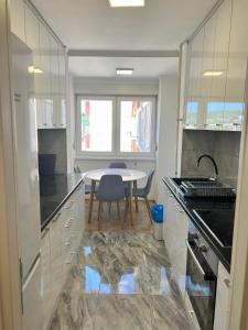 a kitchen with a table and a dining room at ELITE Brcanska Malta in Tuzla