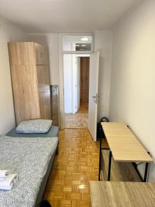 a small room with two beds and a table at ELITE Brcanska Malta in Tuzla