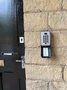 a remote control on the side of a brick wall at The Lookout@brighouse in Brighouse