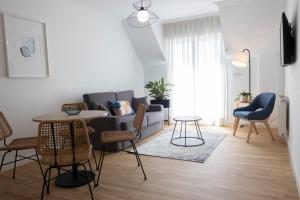 a living room with a couch and a table and chairs at Hotel Maruxia *** Superior in O Grove