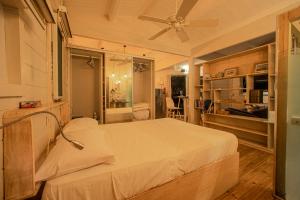 a bedroom with a bed and a ceiling fan at Between2Waters Chalet rental car offered in Tamarin