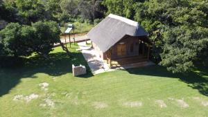 an overhead view of a small cabin in a field of grass at Olievenfontein Private Game Reserve in Behoudeniskloof