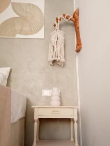 a bedroom with a table and a bed with a shelf at Summer Feel suites in Poros