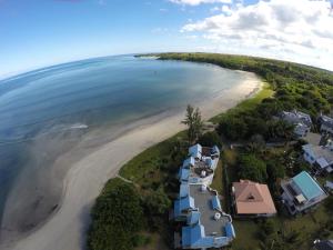 an aerial view of a beach with houses at Between2Waters Chalet rental car offered in Tamarin