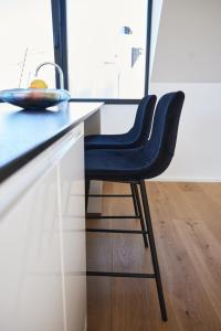een blauwe stoel aan een aanrecht in een keuken bij Designapartment Salzburg in Salzburg