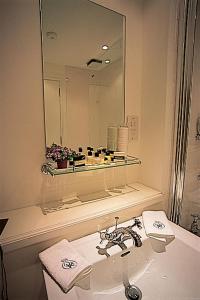 a bathroom with a sink and a mirror at The Royal Hotel in Comrie