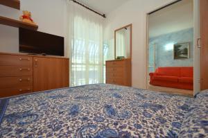 リニャーノ・サッビアドーロにあるResidenza Olimpoのベッドルーム1室(ベッド1台、赤いソファ付)