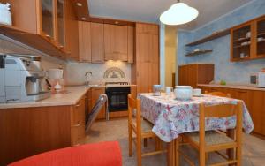 a kitchen with a table with a table cloth on it at Residenza Olimpo in Lignano Sabbiadoro