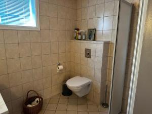 a small bathroom with a toilet and a window at Seaside Comfort with Terrace - Business and Leisure Friendly in Tønsberg +16 photos