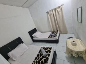 Postel nebo postele na pokoji v ubytování Rainbow Lodge Tambatuon