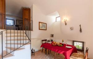 a dining room with a table with a red table cloth at Vacanza Valentia in Vasciano Nuovo