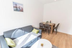 a living room with a couch and a table at Apartman Krželj B4 in Livno