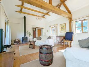 a living room with a barrel in the middle at The Cottage at Hale Hill Farm, Pulborough in Pulborough