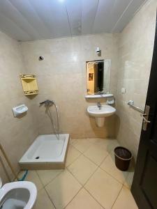 a bathroom with a sink and a toilet and a mirror at porto marina north coast alamein in El Alamein
