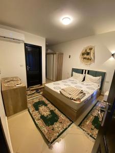 a bedroom with a bed with a rug on the floor at porto marina north coast alamein in El Alamein