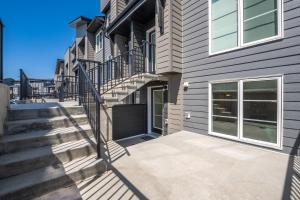 a house with a staircase and a building at Cozy Rockland Park Unit+Parking in Calgary