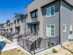 a row of houses with balconies on a street at Cozy Rockland Park Unit+Parking in Calgary