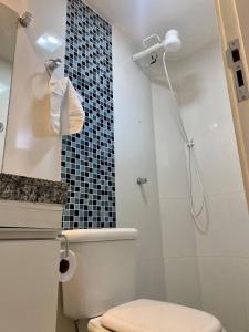 uma casa de banho com um WC e um chuveiro com uma toalha em Apartamento perfeito, bem localizado, confortável, espaçoso e com bom preço insta thiagojacomo em Goiânia