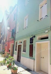 a building with a garage on the side of it at La Bricola - Sirocco e Garbin in Chioggia