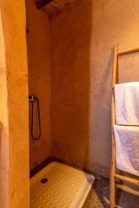 Agafay, La Ferme Nomade Bivouac في El Karia: دش في غرفة صغيرة مع كرسي