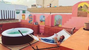 a couple of hammocks sitting on top of a building at Doña Rose Coliving in Las Palmas de Gran Canaria