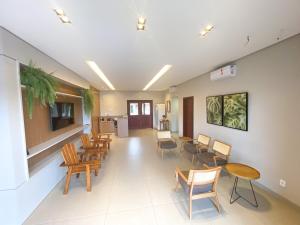 an empty waiting room with chairs and tables at Estância Hotel in Jardim