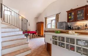 a kitchen with a staircase and a dining room at Vacanza Valentia in Vasciano Nuovo