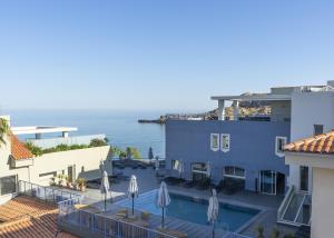 a view of a hotel with a swimming pool and the ocean at Best Western Premier Santa Maria in Lʼ&Icirc;le-Rousse