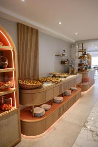 a kitchen with a bunch of food on display at Best Western Premier Santa Maria in LʼÎle-Rousse